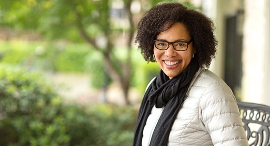 woman smiling in a coat outside