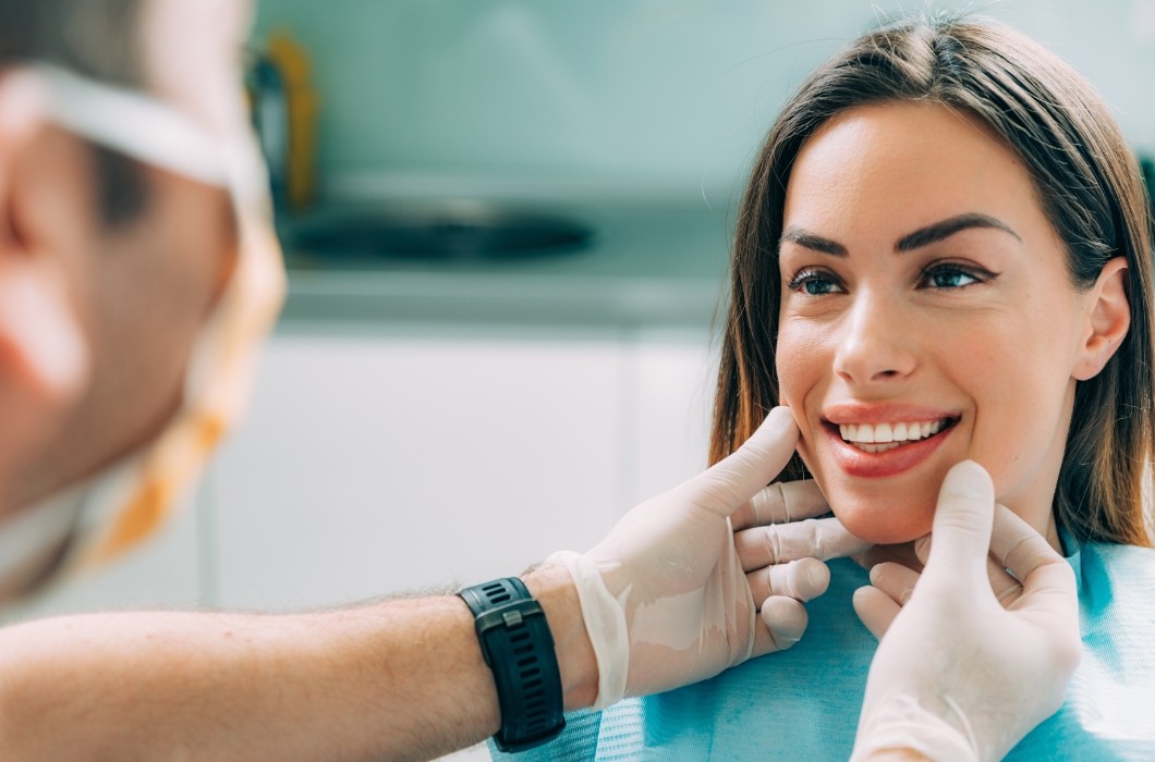 Dentist examining patient's smile during preventive dentistry visit