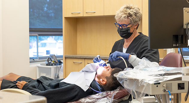 Dentistry team member providing dental checkup and teeth cleaning