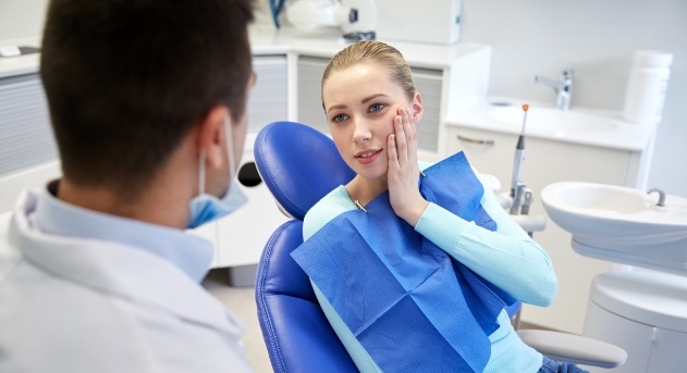 Woman talking to dentist during emergency dentistry visit