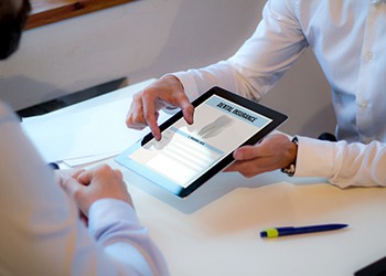 A dental patient discussing dental insurance with an insurance agent