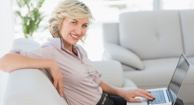 Woman smiling after dental implant tooth replacement