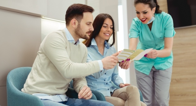 Dental team member discussing dental insurance coverage with dentistry patients