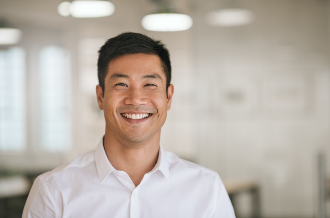 Man with full healthy smile after replacing missing teeth