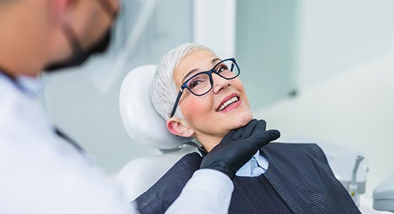 Dentist and mature patient talking during consultation