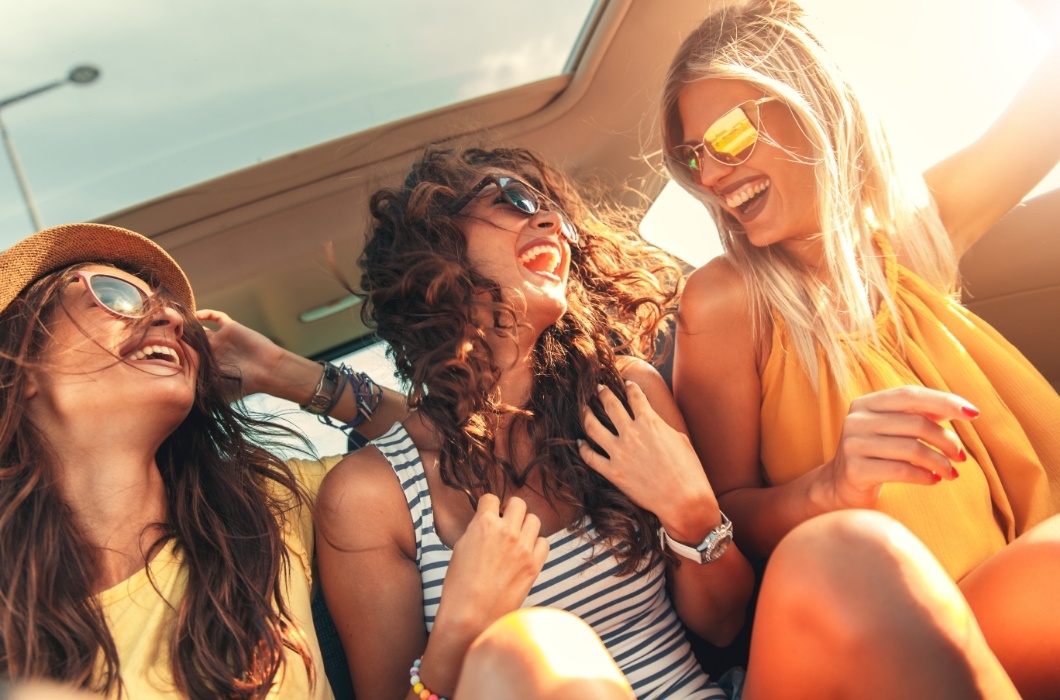 Three friends laughing together after dental services in Lakewood Colorado