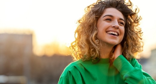 Woman with healthy smile after emergency dentistry