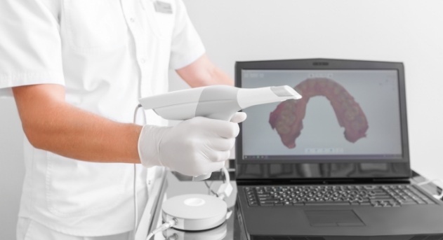 Dental team member using intraoral camera system