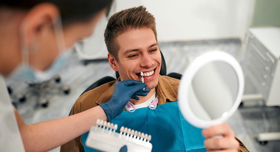 Patient in Lakewood talking to dentist after teeth whitening