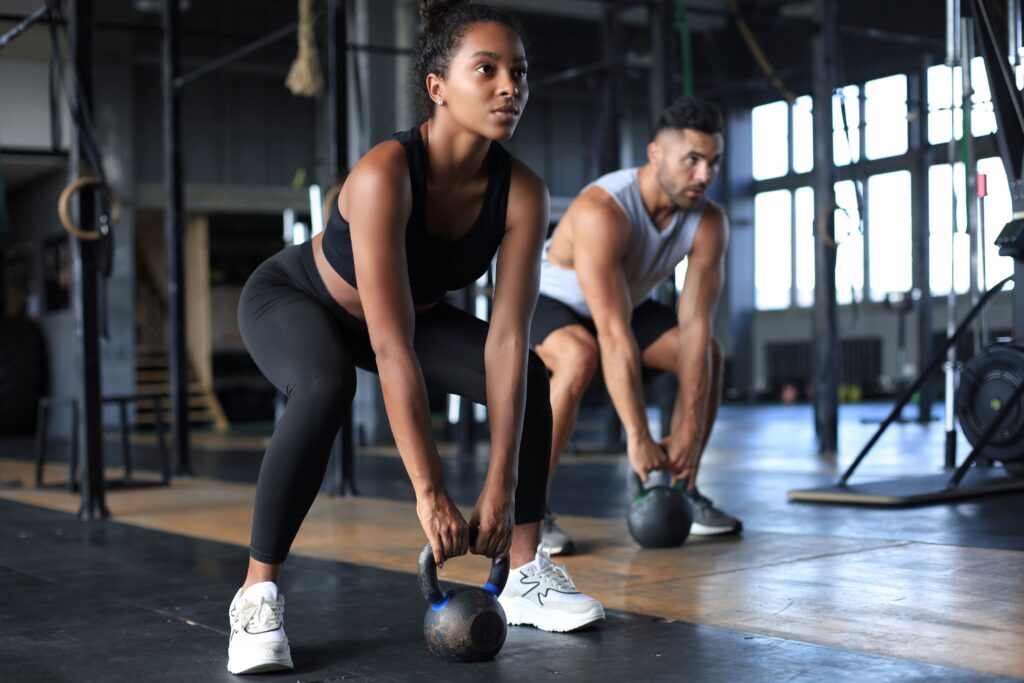 Man and woman exercising at gym